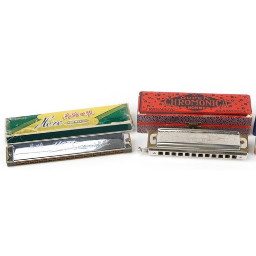 1690 - Four vintage and later harmonicas with cases comprising Hero, Blues Harp and two M Hohners