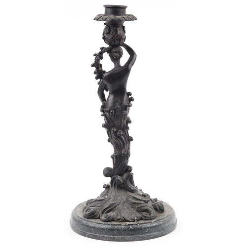 275 - Classical patinated bronze candlestick in the form of a semi nude female on waves, raised on a circu... 