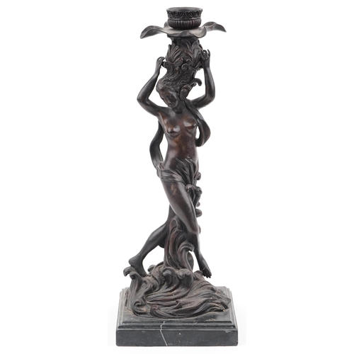 274 - Classical patinated bronze candlestick in the form of a semi nude female on waves, raised on a squar... 