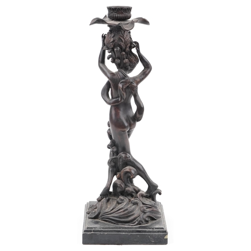 274 - Classical patinated bronze candlestick in the form of a semi nude female on waves, raised on a squar... 