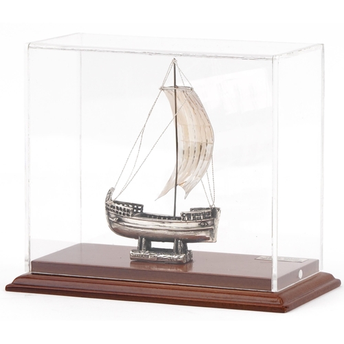 494 - 950 grade silver model of The Ship of Kyrenia housed in a display case, overall 14.5cm high, weighab... 