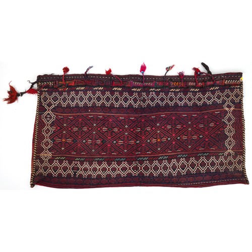 1227A - Rectangular Afghan red ground saddle bag having an allover repeat design, 150cm x 80cm