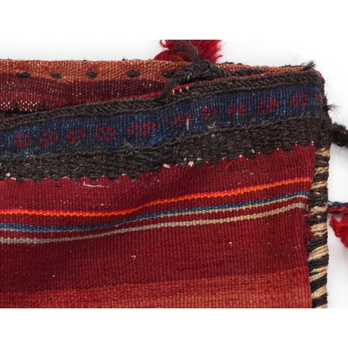 1227A - Rectangular Afghan red ground saddle bag having an allover repeat design, 150cm x 80cm