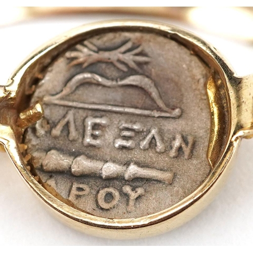 2209 - Antique Greek silver coin housed in a 14ct gold ring mount, impressed Warrior, size O/P, 4.1g