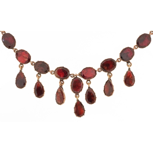 19th century rose gold oval garnet fringe necklace with closed foil backs, the clasp stamped 9KT, 42cm in length, 14.4g