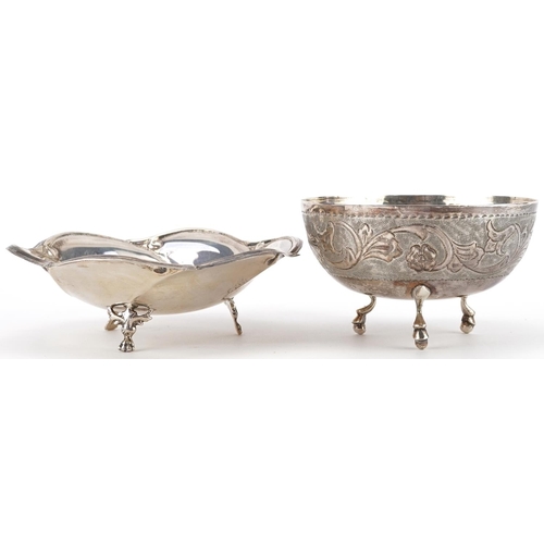 266 - Two circular silver three footed dishes, one engraved with flowers and foliage, the largest 13.5cm i... 