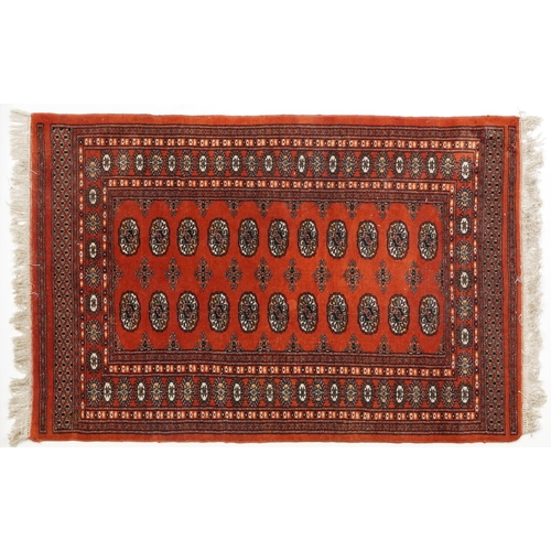 1227 - Rectangular Turkish Bokhara peach ground rug having an allover repeat flower head design, 150cm x 98... 