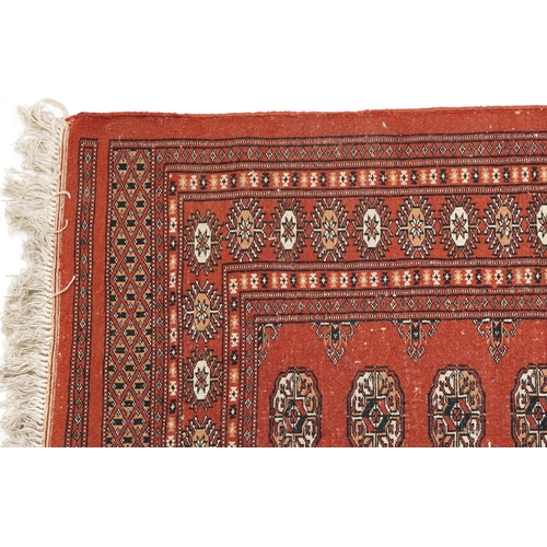 1227 - Rectangular Turkish Bokhara peach ground rug having an allover repeat flower head design, 150cm x 98... 