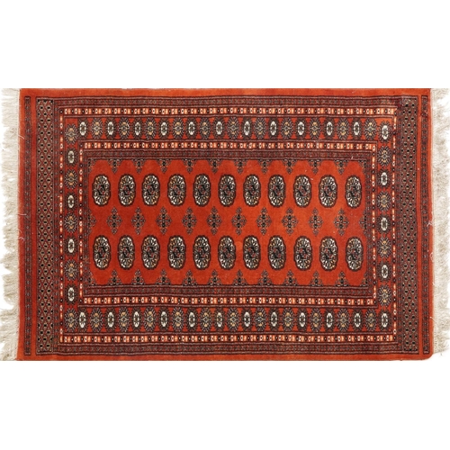 1227 - Rectangular Turkish Bokhara peach ground rug having an allover repeat flower head design, 150cm x 98... 