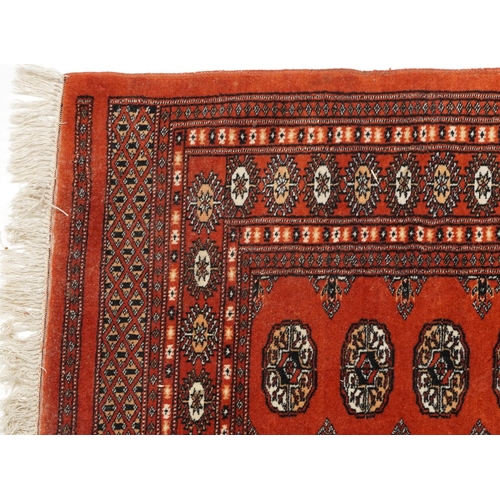 1227 - Rectangular Turkish Bokhara peach ground rug having an allover repeat flower head design, 150cm x 98... 