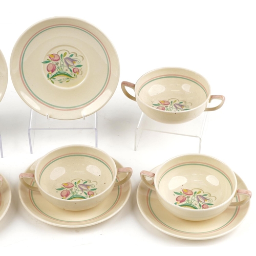 1539 - Set of six Susie Cooper twin handled soup bowls and saucers decorated with stylised flowers, each sa... 