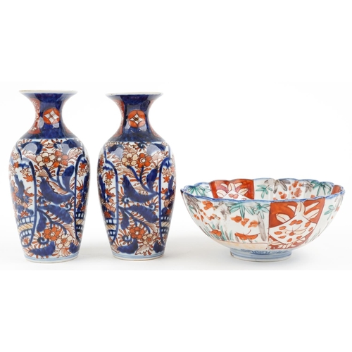 1422 - Japanese Imari porcelain including a pair of vases hand painted with flowers, the largest 19cm high