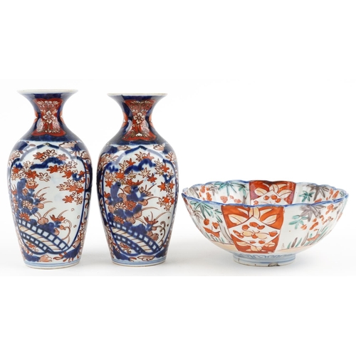 1422 - Japanese Imari porcelain including a pair of vases hand painted with flowers, the largest 19cm high