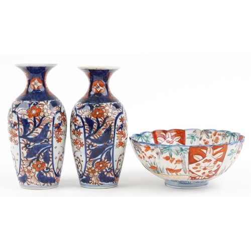 1422 - Japanese Imari porcelain including a pair of vases hand painted with flowers, the largest 19cm high