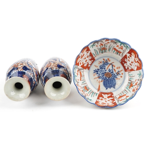 1422 - Japanese Imari porcelain including a pair of vases hand painted with flowers, the largest 19cm high