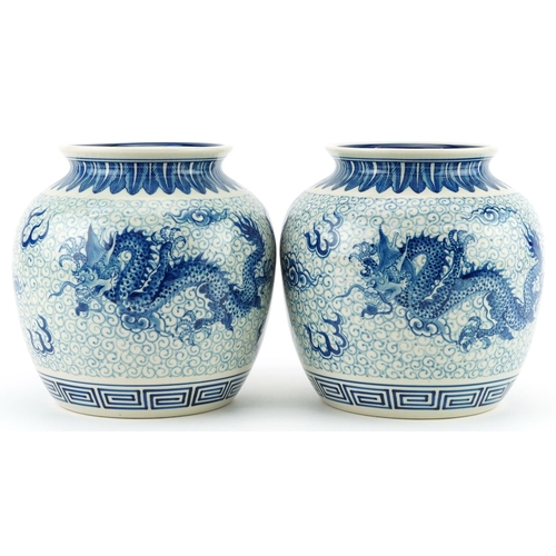 1533 - Pair of Chinese blue and white porcelain jar vases hand painted with dragons chasing the flaming pea... 