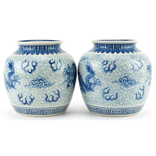 1533 - Pair of Chinese blue and white porcelain jar vases hand painted with dragons chasing the flaming pea... 