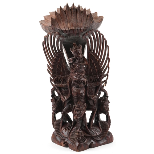 1468 - Large Burmese hardwood carving of a deity and mythical animals, 56cm high