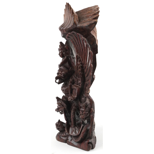 1468 - Large Burmese hardwood carving of a deity and mythical animals, 56cm high