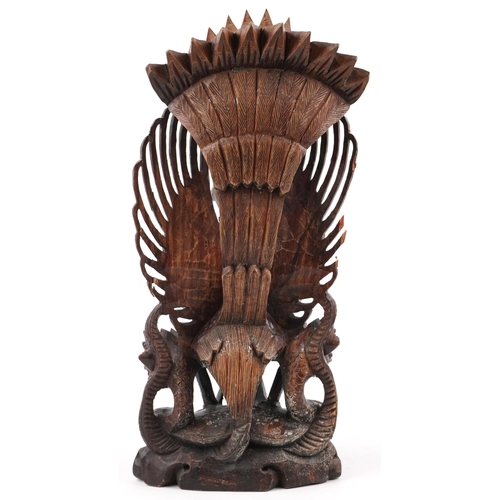 1468 - Large Burmese hardwood carving of a deity and mythical animals, 56cm high