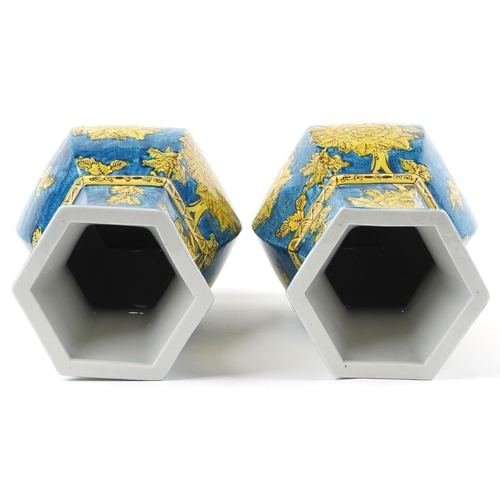 1396 - Pair of Chinese porcelain hexagonal blue ground vases hand painted with flowers, each 40cm high