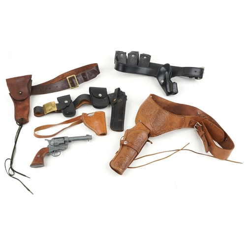 1919 - Decorative cast Colt single action army revolver and five leather holsters, four with belts