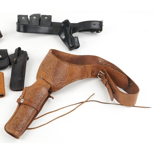 1919 - Decorative cast Colt single action army revolver and five leather holsters, four with belts