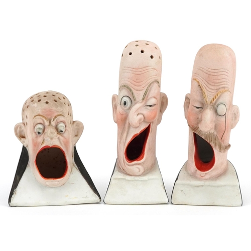 Schafer & Vater, three smoking interest early 20th century German bisque smoking head ashtrays, the largest 13cm high