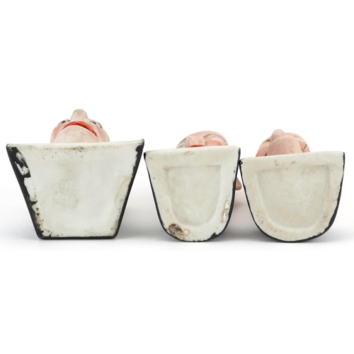 537 - Schafer & Vater, three smoking interest early 20th century German bisque smoking head ashtrays, the ... 