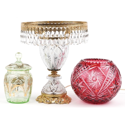 1398 - Glassware including Bohemian ruby overlaid cut glass vase and a glass and brass lamp with drops, the... 