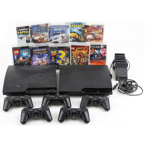 1597 - Two Sony PlayStation 3 games consoles with five controllers, docking station and games including Tom... 