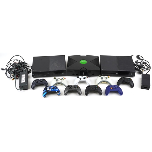 1593 - Three Xbox games consoles and nine Xbox controllers