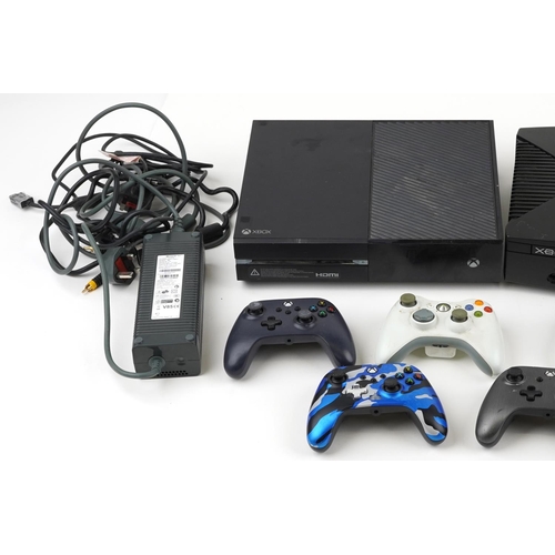 1593 - Three Xbox games consoles and nine Xbox controllers