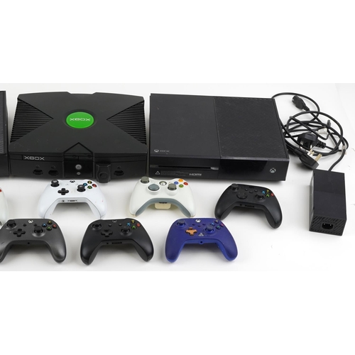 1593 - Three Xbox games consoles and nine Xbox controllers