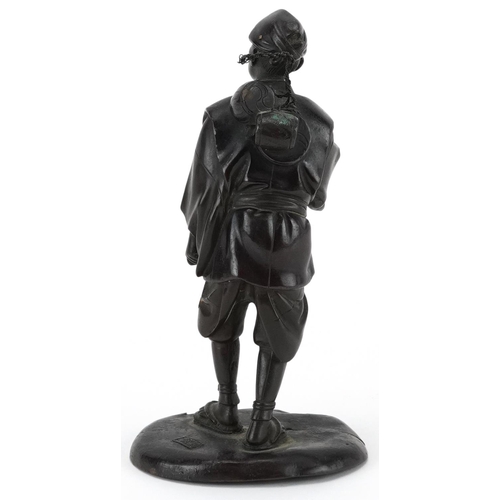 570 - Japanese patinated bronze okimono of a street trader, Meiji period, character marks to the base, 14.... 