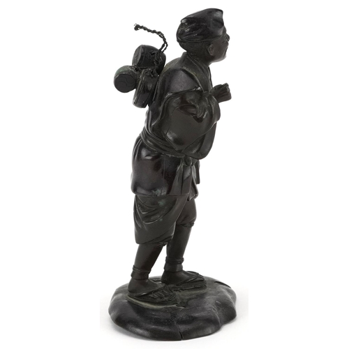 570 - Japanese patinated bronze okimono of a street trader, Meiji period, character marks to the base, 14.... 