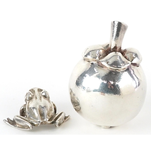 400 - Silver model of a seated frog and a silver filled model of a pome fruit, the largest 7.5cm high, tot... 