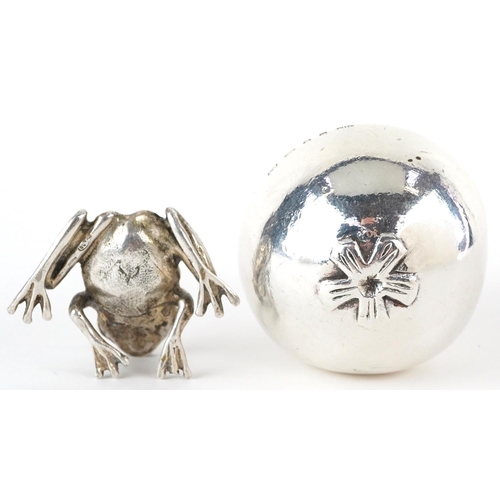 400 - Silver model of a seated frog and a silver filled model of a pome fruit, the largest 7.5cm high, tot... 