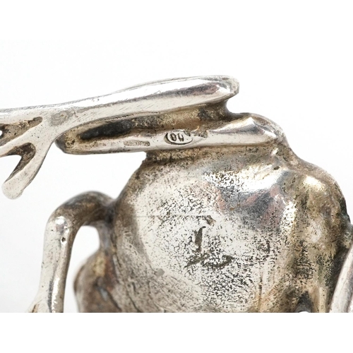 400 - Silver model of a seated frog and a silver filled model of a pome fruit, the largest 7.5cm high, tot... 