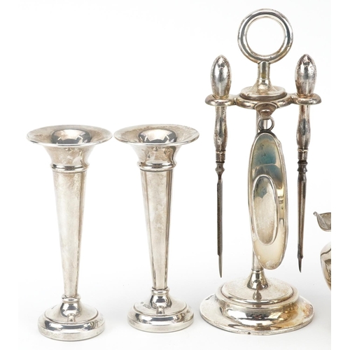 174 - Edwardian and later silver including vanity tools on stand, pair of miniature trumpet shaped vases a... 