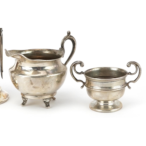 174 - Edwardian and later silver including vanity tools on stand, pair of miniature trumpet shaped vases a... 