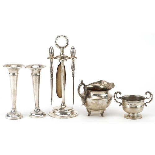 174 - Edwardian and later silver including vanity tools on stand, pair of miniature trumpet shaped vases a... 