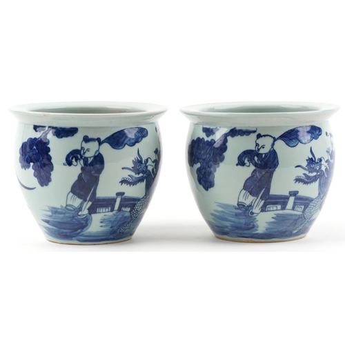 619 - Pair of Chinese blue and white porcelain jardinieres painted with children playing in a palace setti... 