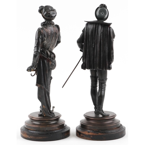 277 - Pair of Victorian patinated spelter figures in 17th century dress raised on circular ebonised wooden... 