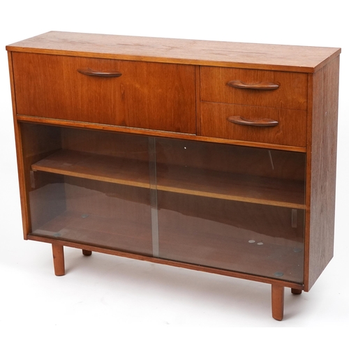 Avalon, mid century teak side cabinet fitted with a fall and two drawers above a pair of glass sliding doors enclosing an adjustable shelf, 91.5cm H x 114cm W x 34cm D