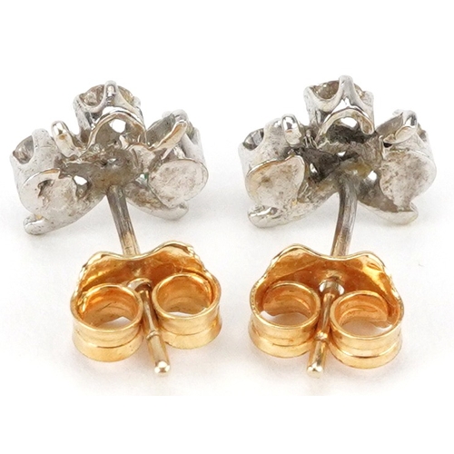 2255 - Pair of unmarked gold diamond three stone stud earrings, the largest diamonds each approximately 2.0... 