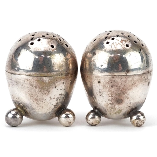 399 - Robert Stebbings, pair of Victorian silver egg shape casters with ball feet, London 1895, each 3.8cm... 