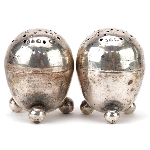 399 - Robert Stebbings, pair of Victorian silver egg shape casters with ball feet, London 1895, each 3.8cm... 