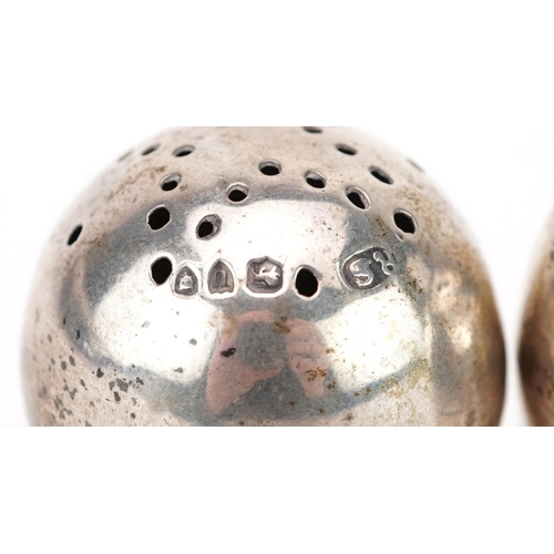 399 - Robert Stebbings, pair of Victorian silver egg shape casters with ball feet, London 1895, each 3.8cm... 