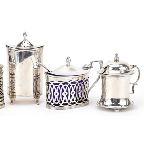 237 - Five Art Deco and later silver cruet items, four with blue glass liners, the largest 9cm wide, weigh... 